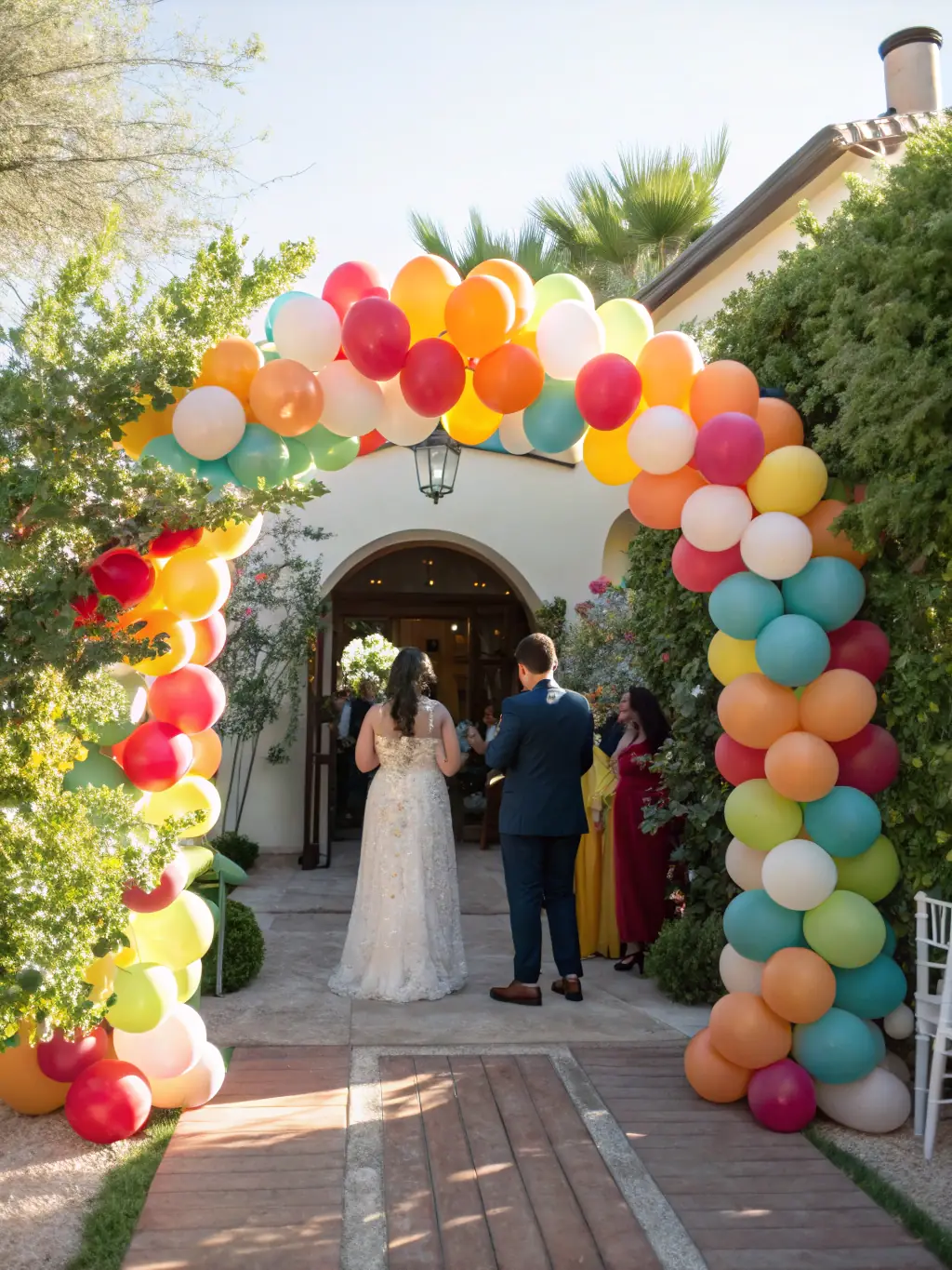 A pair of intertwined balloon arches in pastel colors, forming a heart shape, perfect for framing the bride and groom during their vows. The arches are decorated with floral accents and soft lighting.